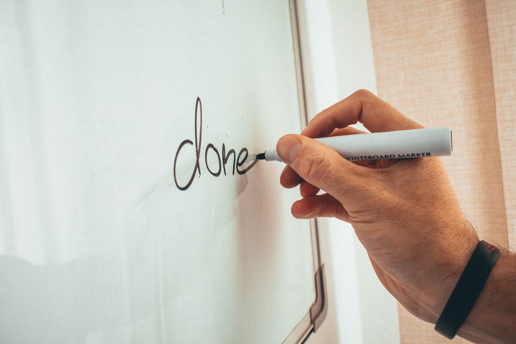 A professional mapping out ideas on an office whiteboard